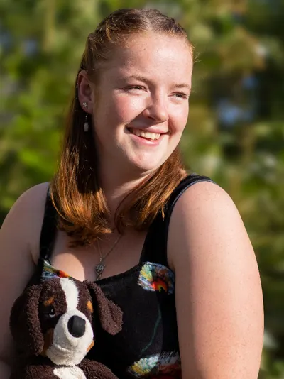 Young woman with her service dog toy
